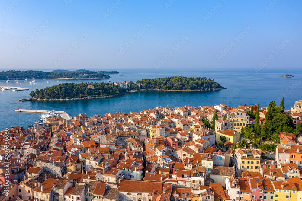 Tiled roofs of the ancient city, located on the beach. Rovinj, Croatia. Shooting from a drone.