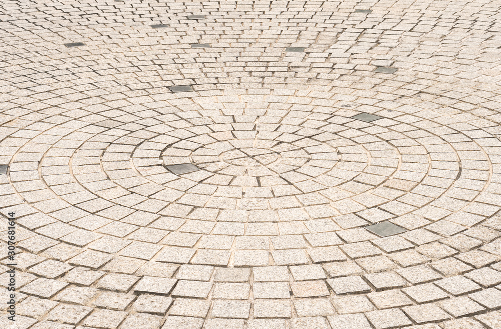 Circle stone tile floor design for footpath in center of urban park, street city exterior background Circle stone tile floor design for footpath in center of urban park, street city exterior background