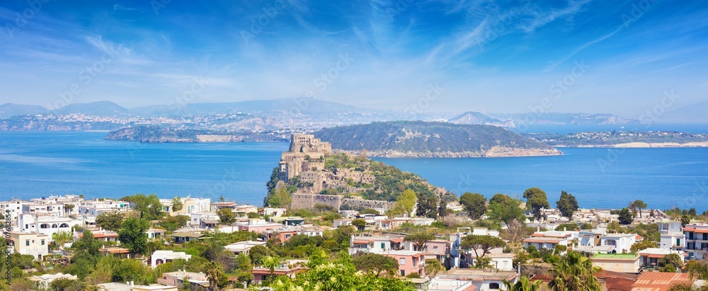 Panoramic aerial view of Gulf of Naples, Ischia Island and famous landmark and tourist destination Aragonese Castle or Castello Aragonese, Italy.