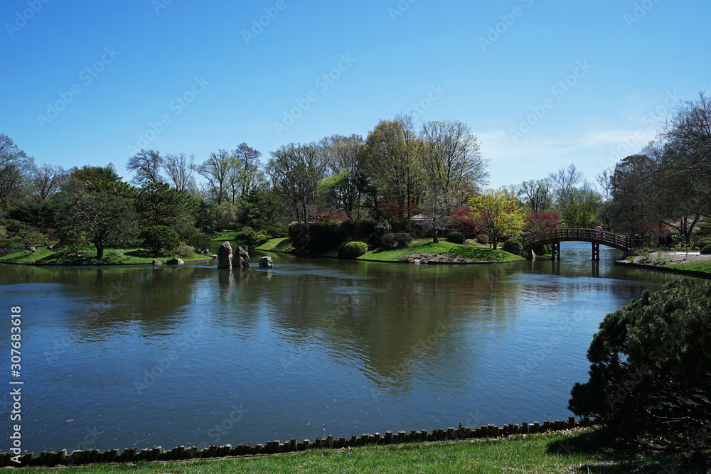 Traditional wooden bridge with garden arranged in Japanese Zen style