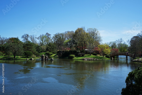 Traditional wooden bridge with garden arranged in Japanese Zen style