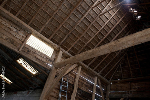 Old wooden barn in Ruinerwold Drenthe Netherlands. With straw roofing. Interior of a farm. © A