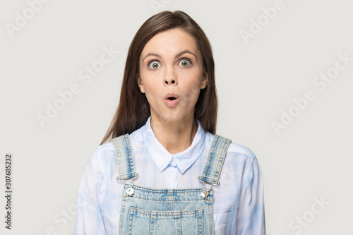 Headshot of nerdy surprised millennial woman showing fishface grimace photo