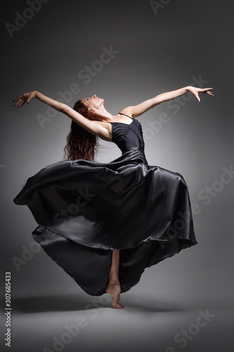  Girl dancer in an elegant, unusual pose. Beautiful girl with long hair in black clothes from a long skirt, dance, uniform, sport, ballet, modern, beautiful, amazing, passion, sexy, unusual, silk