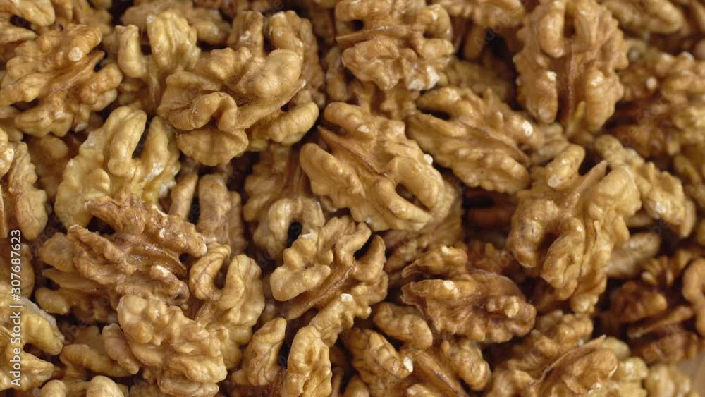 Walnut close up. product rich in minerals and vitamins. Walnut turns in a shot. Walnut kernels rotating. walnut close up lies under beams of the sun. Macro Walnut close up. product rich in minerals and vitamins. Walnut turns in a shot. Walnut kernels rotating. walnut close up lies under beams of the sun. Macro