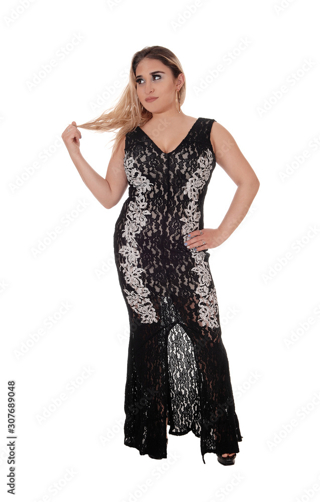 Beautiful young woman standing in a long dress Beautiful young woman standing in a long dress
