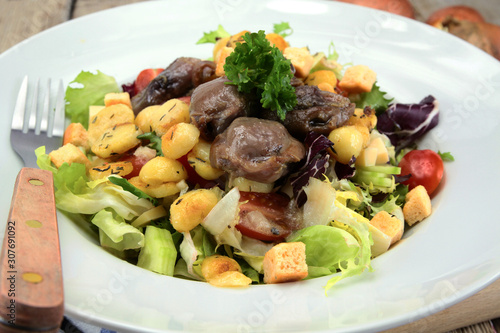plate of gizzard salad and potatoes