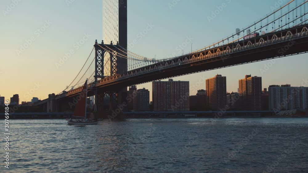 A boat sailing under the Manhattan Bridge in New York A boat sailing under the Manhattan Bridge in New York