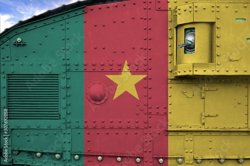 Cameroon flag depicted on side part of military armored tank closeup. Army forces conceptual background photo