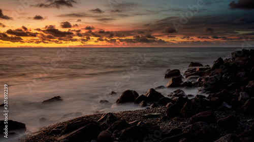 colorful sunset over rocky beach on madeira
