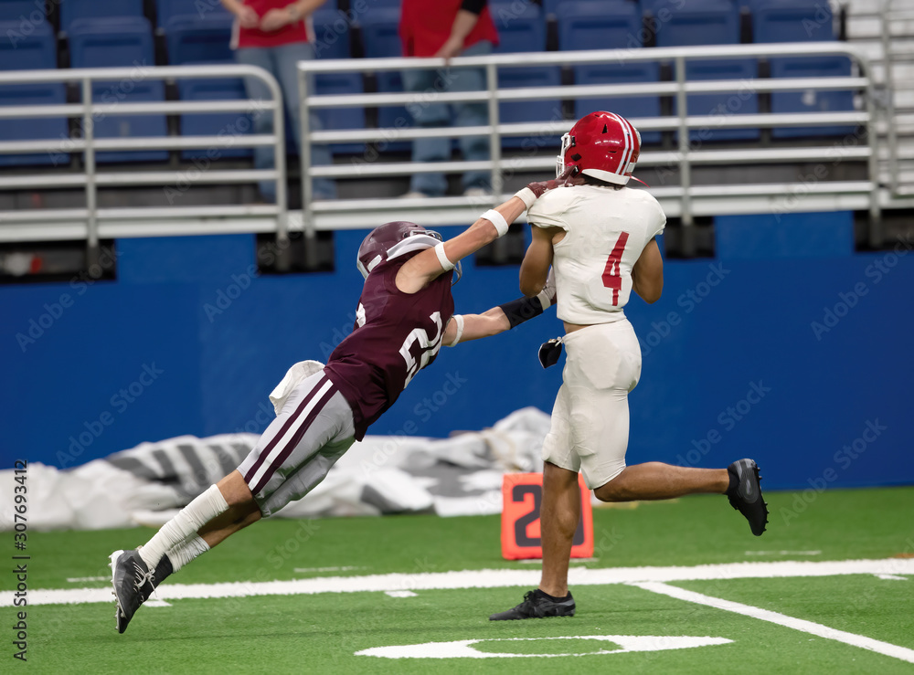 Fototapeta premium Great action photos of high school football players making amazing plays during a football game