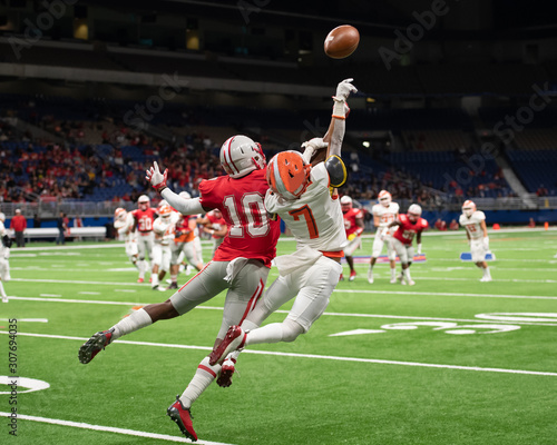 Great action photos of high school football players making amazing plays during a football game photo