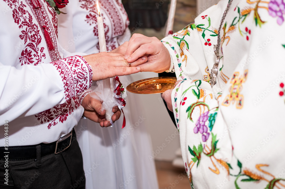 Priest dresses wedding rings on the finger