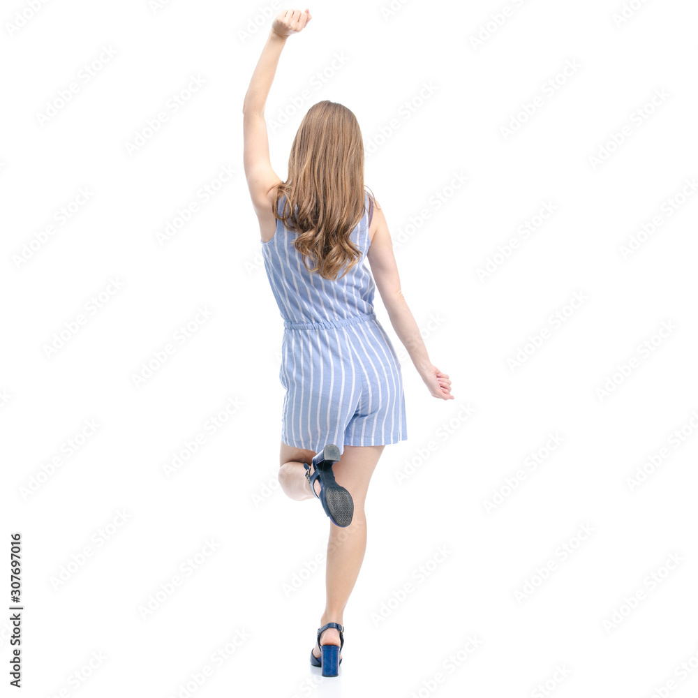 Woman in blue overalls fashion happiness dancing smiling on white background isolation, back view Woman in blue overalls fashion happiness dancing smiling on white background isolation, back view