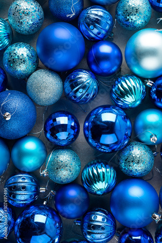 Christmas, New Year blue background in low key. Monochrome christmas balls and decor.