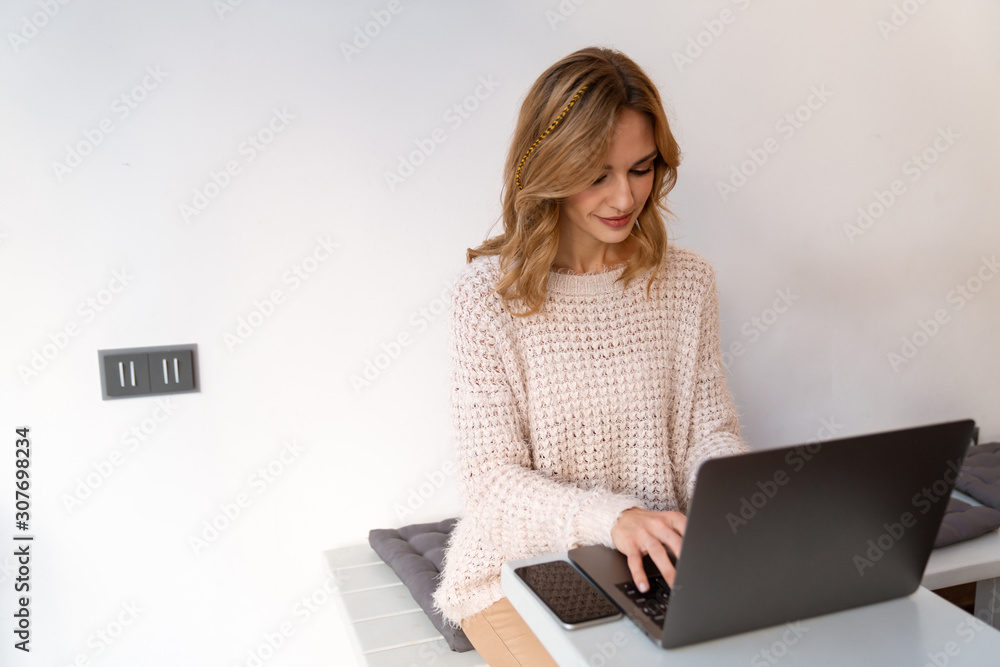 Positive cheery young blonde woman sit in cafe