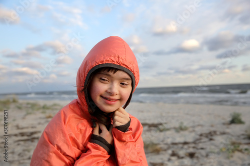 Portrait of down syndrome girl smiling on background of the sea © denys_kuvaiev