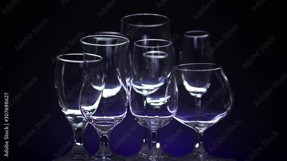 Nightclub counter with different shaped empty glasses for a wine, slow motion spinning in the bar. Christmas or New Year party mood concept. Close up. Nightclub counter with different shaped empty glasses for a wine, slow motion spinning in the bar. Christmas or New Year party mood concept. Close up.
