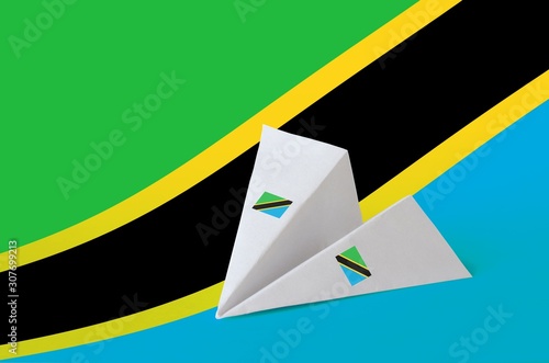 Tanzania flag depicted on paper origami airplane. Handmade arts concept photo