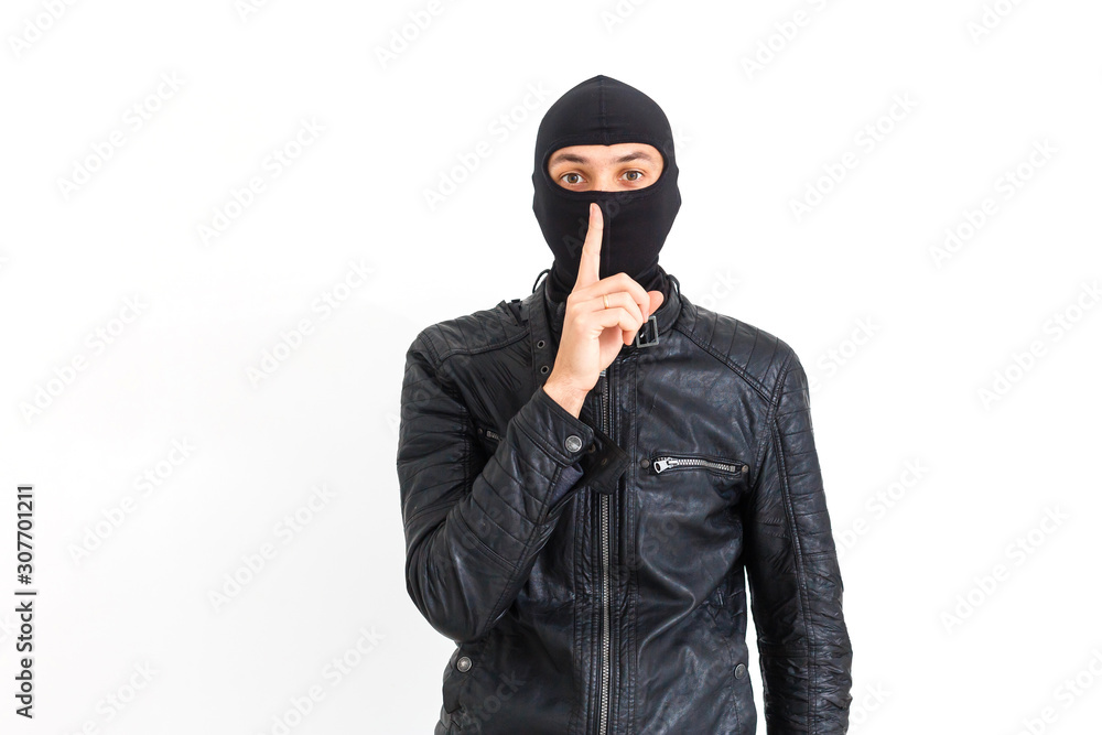 Thief in a mask showing sign quieter Thief in a mask showing sign quieter