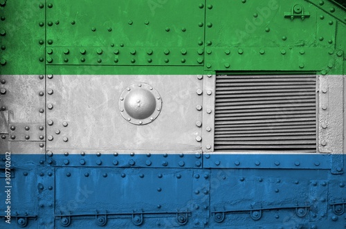 Sierra Leone flag depicted on side part of military armored tank closeup. Army forces conceptual background photo