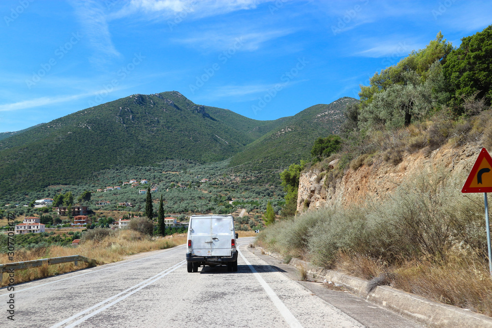 Car on a scenic greek rural road in the mountains of Peloponnese, Greece