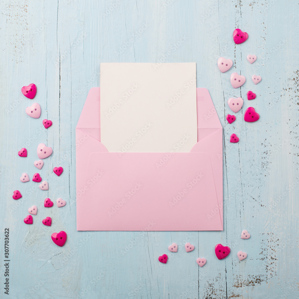 Pink paper envelope with pink hearts, blue background Pink paper envelope with pink hearts, blue background