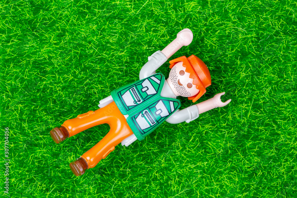 Concept of freedom or relaxation with a playmobil lying on the ground in  the grass foto de Stock | Adobe Stock