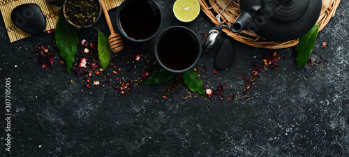 Set traditional Chinese tea on black stone background. Tea in teapot and cup. Top view. free space for your text.