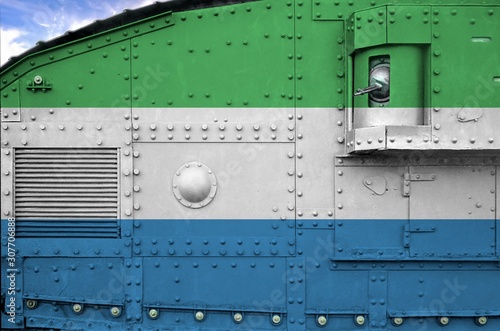 Sierra Leone flag depicted on side part of military armored tank closeup. Army forces conceptual background photo