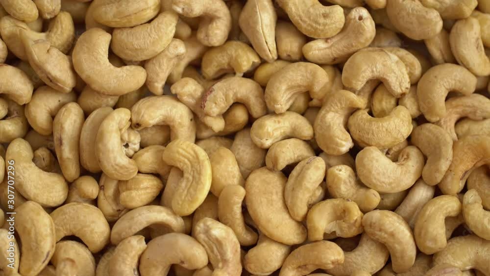 Walnut close up. product rich in minerals and vitamins. Cashew turns in a shot. Cashew kernels rotating. Cashew close up lies under beams of the sun. Macro 4K Walnut close up. product rich in minerals and vitamins. Cashew turns in a shot. Cashew kernels rotating. Cashew close up lies under beams of the sun. Macro 4K