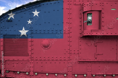 Samoa flag depicted on side part of military armored tank closeup. Army forces conceptual background photo