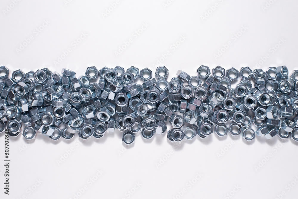 shiny steel nuts in close-up on a white background shiny steel nuts in close-up on a white background