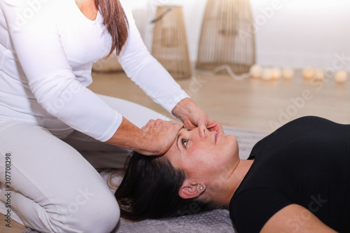 Traditional shiatsu massage done by mature therapist.