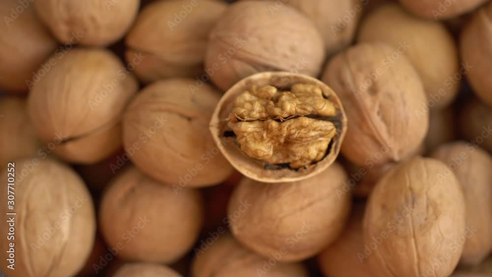 Walnut close up. product rich in minerals and vitamins. Walnut turns in a shot. Walnut kernels rotating. walnut close up lies under beams of the sun. Macro Walnut close up. product rich in minerals and vitamins. Walnut turns in a shot. Walnut kernels rotating. walnut close up lies under beams of the sun. Macro