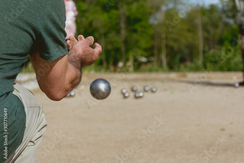 Senior people playing bocce in a park photo