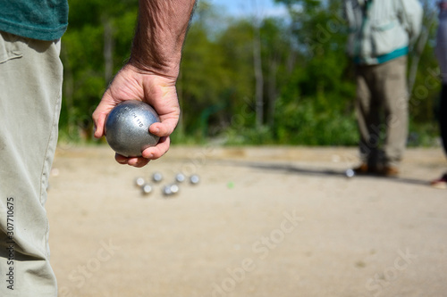 Senior people playing bocce in a park