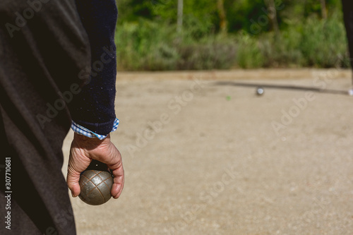 Senior people playing bocce in a park