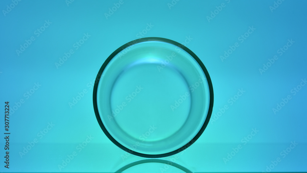 Glass cylinder on a glass table. Abstract still life. Glass cylinder on a glass table. Abstract still life.