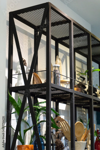 Metal shelving with show piece decorations in a coffee shop.