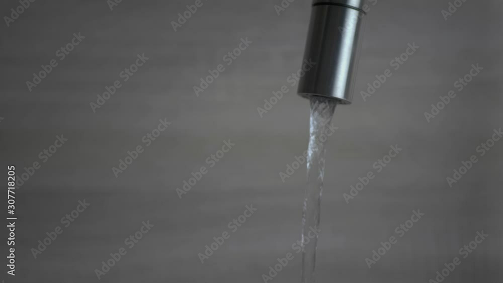 Water Dripping From The Faucet in The kitchen at Home.- Close Up Shot Water Dripping From The Faucet in The kitchen at Home.- Close Up Shot
