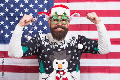 best party ever. Christmas in usa. Santa on american flag background. Bearded american man celebrate new year. National us flag. Patriotic hipster celebrate winter holidays. All american xmas party © be free