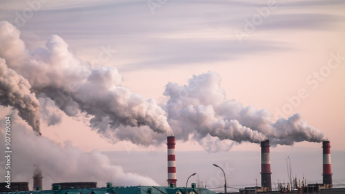 Fotografie industrial chimneys with heavy smoke causing air pollution as ecological problem