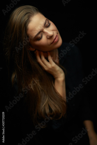 Beautiful woman isolated portrait on black with closed eyes.