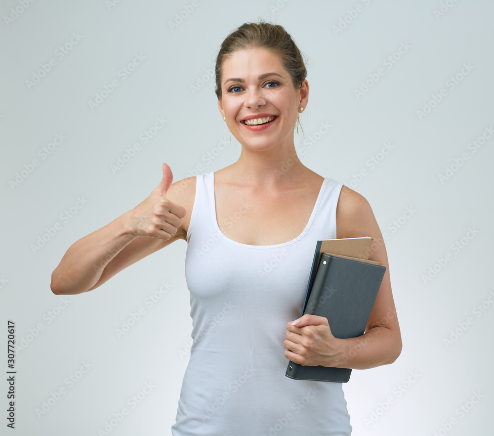 woman holding books showing thumb up. woman holding books showing thumb up.