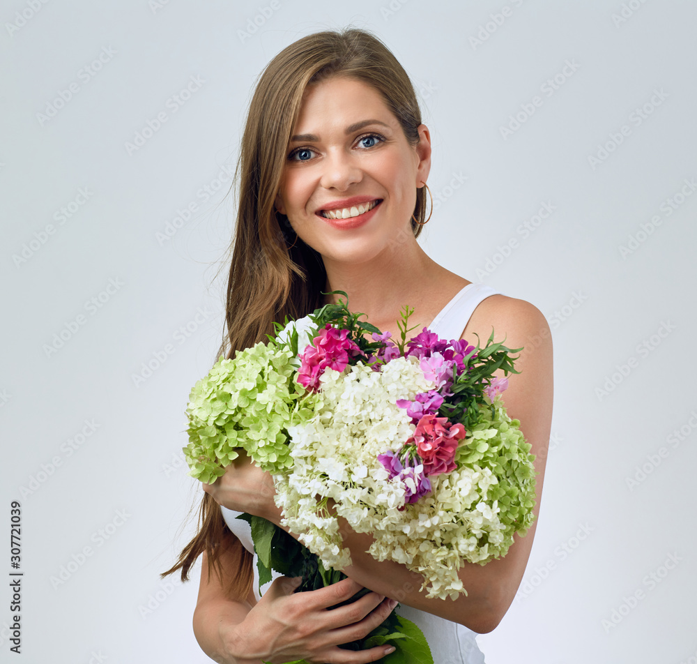 woman with long hair in white casual dress holding flowers bouquet. woman with long hair in white casual dress holding flowers bouquet.