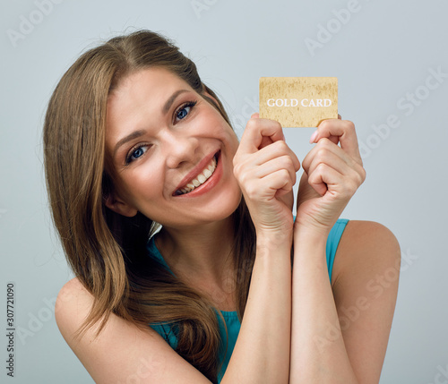 woman with big toothy smile holding credit card photo