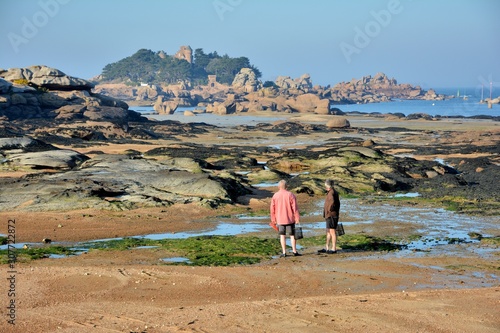 Two fishermen who are watching the sea at low tide in Brittany. France photo