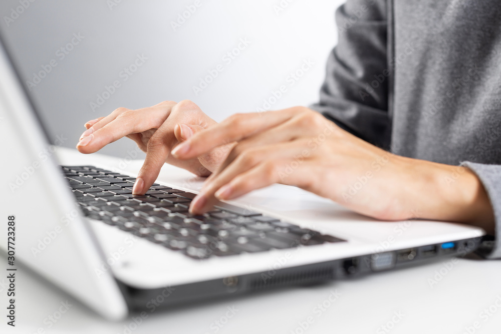 Student sitting at desk and working at laptop Student sitting at desk and working at laptop