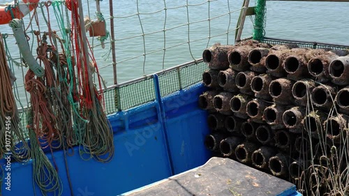 Traditionally portuguese fishing boat on a pier with fishing tackle. In tavira Cabanas.
